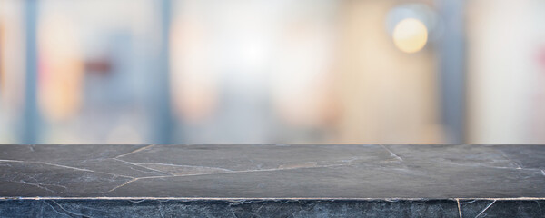 Empty black marble stone table top and blur glass window interior restaurant banner mock up...