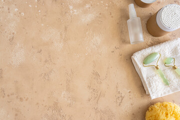 Eco friendly beauty accessories. Natural sea sponge and soap , biodegradable swabs, glass serum bottle, jade roller and organic cotton towel. Zero waste living.