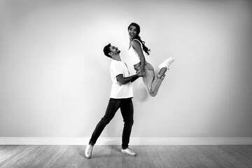 Fototapeta na wymiar Beautiful young couple dancing in modern studio