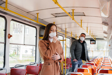 Obraz na płótnie Canvas Passengers on public transport during the coronavirus pandemic keep their distance from each other. Protection and prevention covid 19