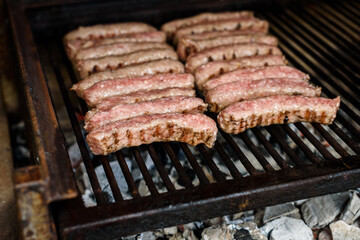 Grilling Meat on barbecue grill with hot coal.