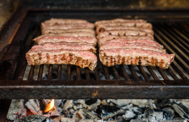 Grilling Meat on barbecue grill with hot coal.