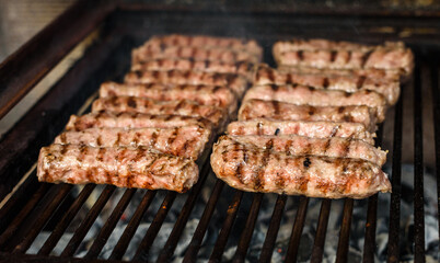 Grilling Meat on barbecue grill with hot coal.