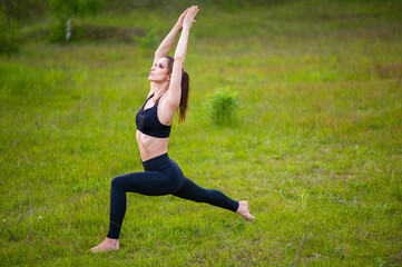 Young woman doing yoga in park. Body positive, outdoor sports