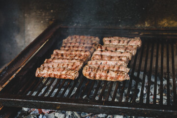 Grilling Meat on barbecue grill with hot coal.