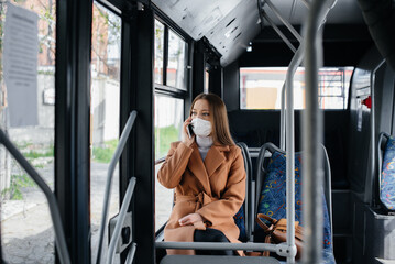 A young girl in a mask uses public transport alone, during a pandemic. Protection and prevention covid 19