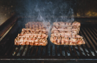 Grilling Meat on barbecue grill with hot coal.