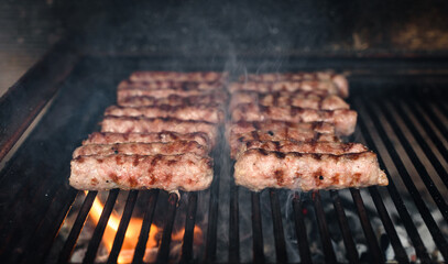 Grilling Meat on barbecue grill with hot coal.