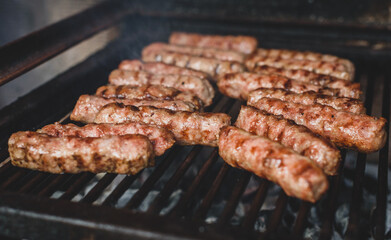 Grilling Meat on barbecue grill with hot coal.