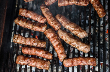Grilling Meat on barbecue grill with hot coal.