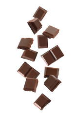 Delicious dark chocolate pieces falling on white background