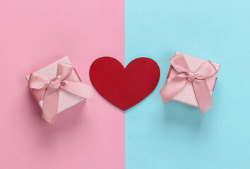 Gift boxes with bows and heart on pink blue pastel background. Holiday, Valentine's Day. Top view. Minimalism