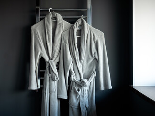 Two dressing gowns hanging in the bathroom