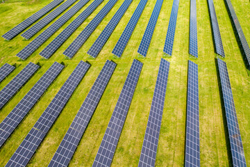 Aerial view to solar power plant. Industrial background on renewable resources theme.