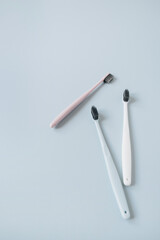 Toothbrushes on blue background. Flat lay, top view oral care, dental hygiene concept.