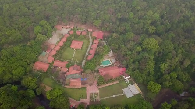 A drone shot flying over the buildings in Goa, India.
