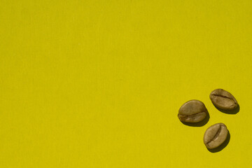 Background of    green coffee beans on yellow paper as background