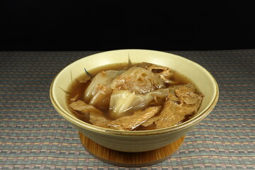 Boiled cutting fresh cabbage with fried yuba (bean curt sheet) seasoning with soy sauce and pepper. Famous traditional soup of vegetarian menu in Asia. Soft tasty with high fiber and nutrition. 