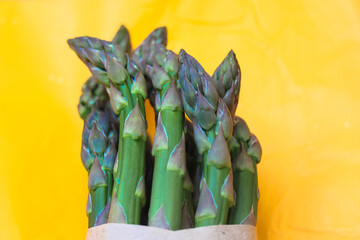 Asparagus. Fresh green asparagus on a bright yellow clear background. 