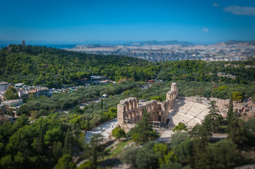 Fototapeta na wymiar Tilt shift effect of Odeo of Herod Atticus theatre view from Acropolis, Athens, Greece. Concept: classical culture, famous monuments, ancient history, cultural travel, visiting unesco world heritage