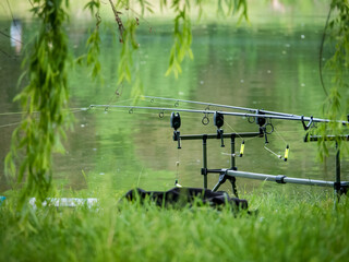 Fishing rod at the edge of a lake in Bucharest. Fishing on a beautiful day
