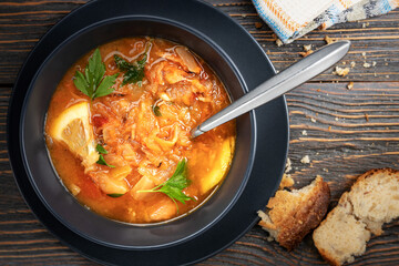 Red soup with vegetables and meat, tasty, appetizing traditional Ukrainian borsch, close-up, top view, shallow depth of field, selective focus. Healthy Home Food Concept