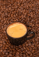 coffee cup with coffee beans on a background of coffee beans