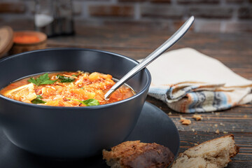 Red soup with vegetables and meat, tasty, traditional Ukrainian borsch, close-up, shallow depth of field, selective focus. Healthy Organic Homemade Food Concept