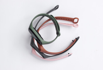 Fototapeta premium Smart bracelet with interchangeable straps on white background. Modern gadgets