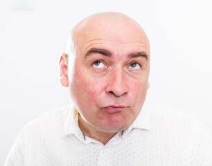 Fototapeta premium portrait of bald adult mature man with emotions on white background