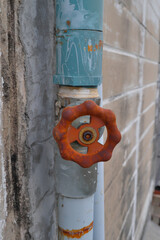 Close up of old Brass water  valve  with Water supply pipe. on the wall.