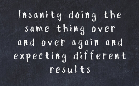 Chalk wise inscription on black chalkboard