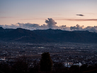 Kofu city in the evening surrounded by mountains