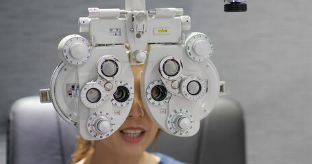 Woman checks her eyes in clinic
