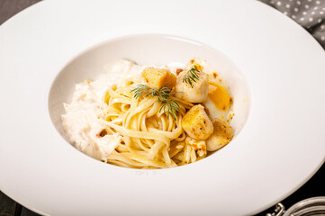 Pasta with fried scallops. Tasty Seafood Dishes. Mediterranean food. Close up
