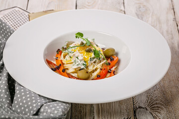 Mediterranean Kitchen. Traditional pasta with vegetables and crab with cream sauce. Cooking in a restaurant