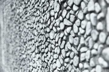 Mauer oder Wand mit vielen grauen Kiesel Steinen