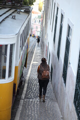 people walking in the street of Lisbon by the yellow tramp