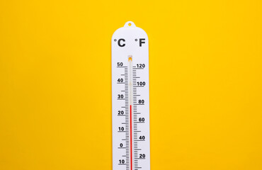 Weather thermometer on yellow background. Climate control. Top view - obrazy, fototapety, plakaty