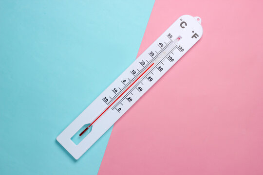 Weather thermometer on a blue-pink pastel background. Climate control. Top view