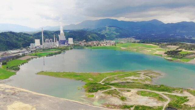 Idyllic Velenje Lake, TES Power Station in background. Panning shot