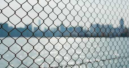 Metallic fencing at seaside in evening