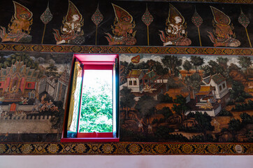 Naklejka na ściany i meble Historic temple wall art in UNESCO World Heritage Site, Ayutthaya, Thailand. With window opens and the light shines in.