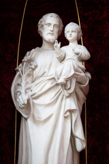 Saint Joseph with Jesus savior marble sculpture. Saint Josef statue in the church.