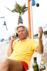 Fototapeta premium Satisfied glad man resting and speaking phone
