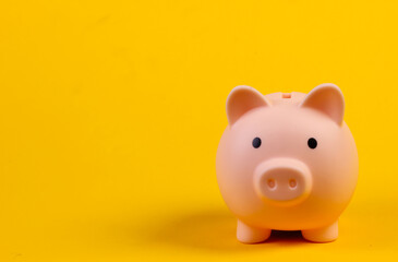 Piiggy bank close-up on yellow background. Minimalism. Copy space