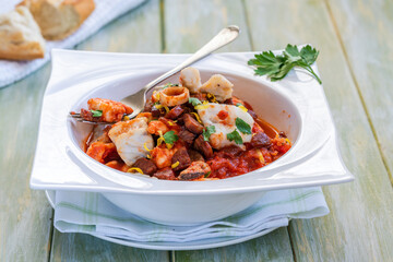 Bouillabaisse (a traditional ProvenÃ§al fish stew) with crispy chorizo and lemon