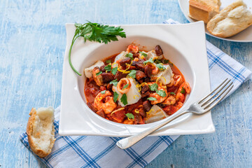 Bouillabaisse (a traditional ProvenÃ§al fish stew) with crispy chorizo and lemon