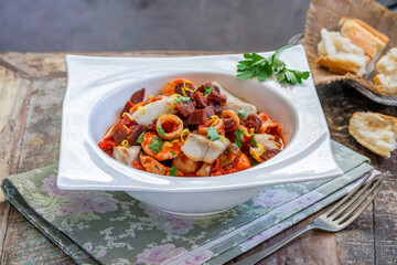 Bouillabaisse (a traditional ProvenÃ§al fish stew) with crispy chorizo and lemon