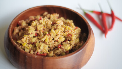 Spicy star gooseberry salad in wood bowl on white background,Thai food
